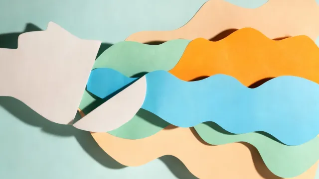 Paper cut collage artwork depicting colorful waves flowing from a silhouette, representing creative thought